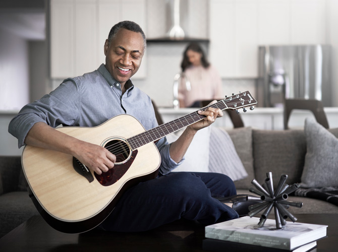 Lennox_DLSC_Brand_day_21723-670×500-1 Man playing guitar in home